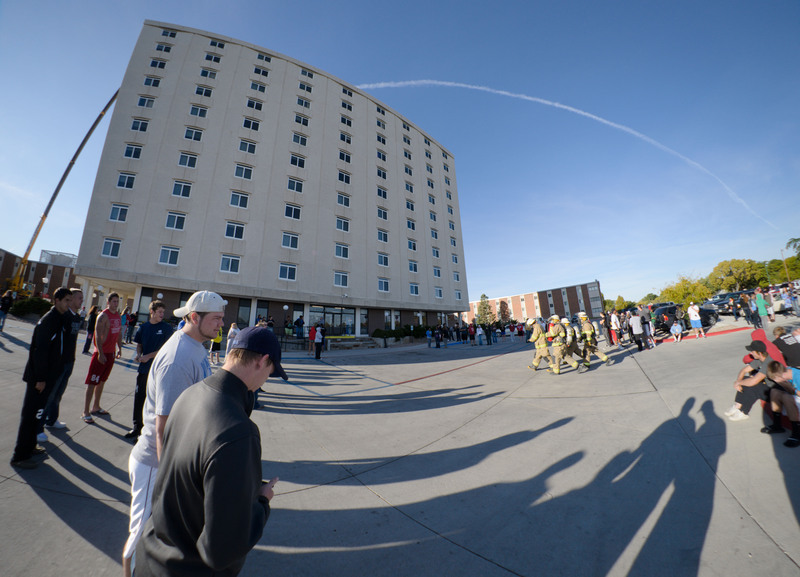 Firefighters move toward the Chadron State College High Rise Residence Hall to investigate the cause of an alarm in the building.