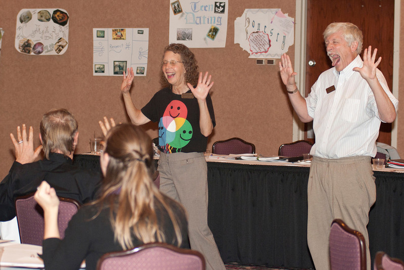 David and Trisha Ferlic of Wheat Ridge, Colo., lead participants of the Civility Improvement Workshop in a laughing exercise.