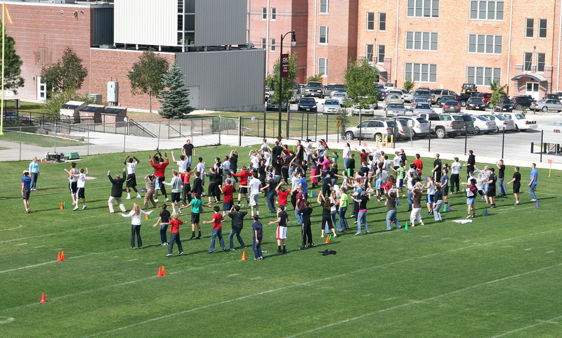 Chadron State College's Health, Physical Education and Recreation Department leads 109 people in jumping jacks for a global effort to set a record.