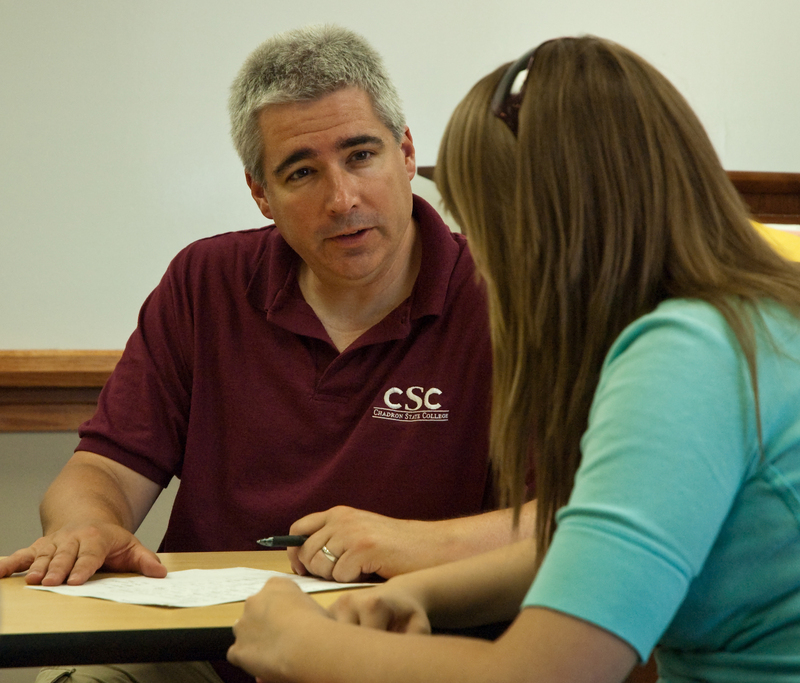 Dr. Michael Stephens of the CSC music faculty advises a student in filling out paperwork during a 2010 registration session.