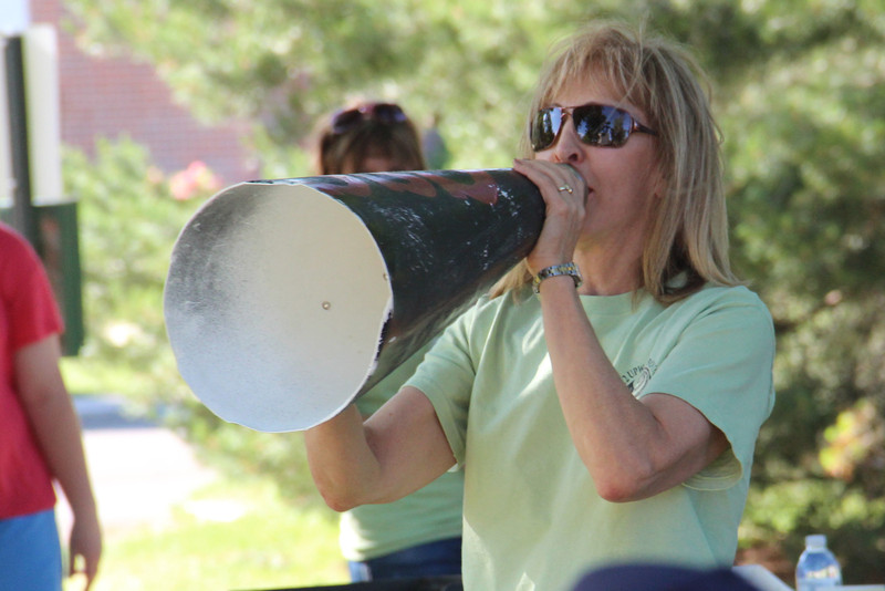 Maggie Smith-Bruehlman, Chadron State College Upward Bound director, uses a vintage megaphone to introduce program staff during the program's kickoff picnic at Memorial Park. (Photo by Justin Haag)