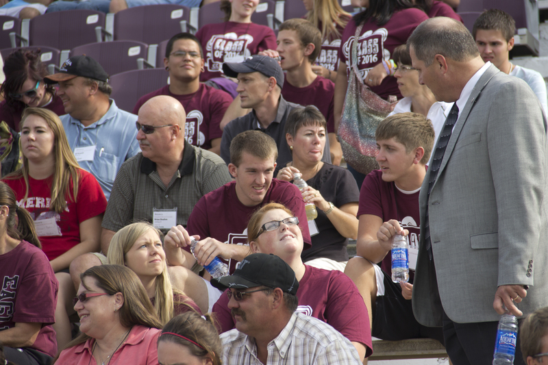 Randy Rhine, interim president of Chadron State College, greets the college's new students as they arrive for an orientation activity at Elliott Field on Aug. 16