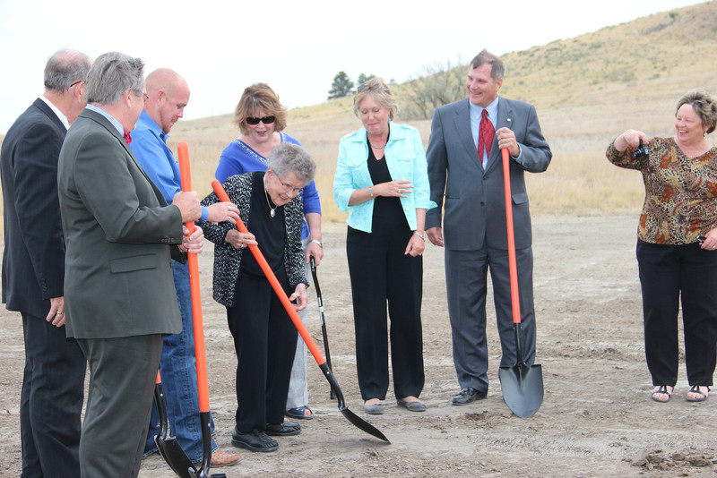 Virginia Coffee, center, uses a shovel to break ground for the first phase of Chadron State College's Rangeland Complex. (Photo by Justin Haag)