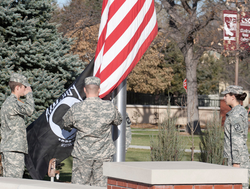 Chadron State College ROTC cadets raise the flags during the Veterans Day ceremony at the Centennial Flag Plaza last year. (Photo by Justin Haag)