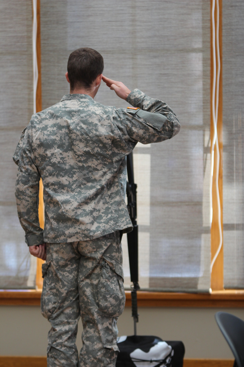 A Chadron State College ROTC member salutes the battlefield cross during the Veterans Day ceremony at the Sandoz Center last month. (Photo by Justin Haag)