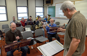 Dr. Michael Stephens conducts a group of high school faculty