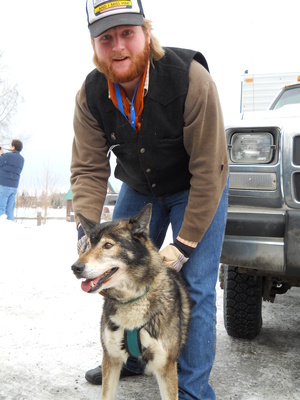 Miles Proctor poses with a sled dog