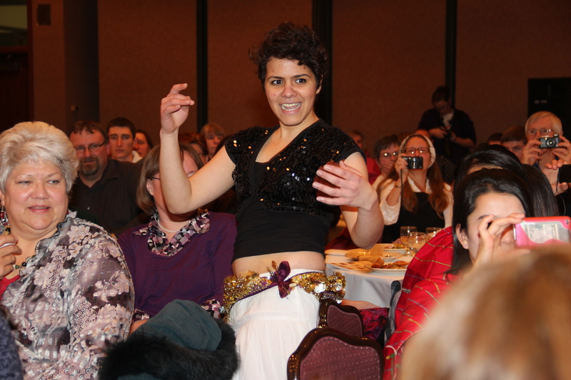 An international exchange student from Egypt dances at the 2013 CSC International Club Food Tasting Party.