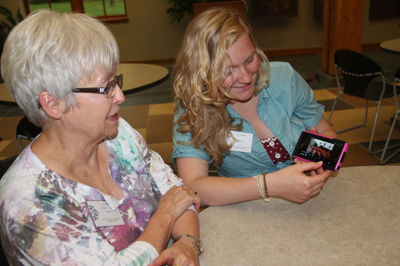 From left, Jane Rice and Tiffani Roelle view a photo of Changing the Guard at Buckingham Palace in May 2013.