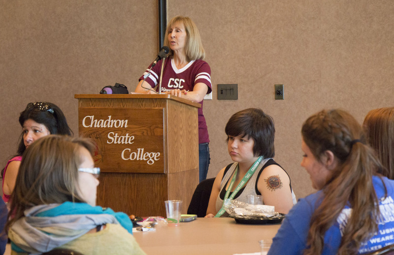 Upward Bound Program Director Dr. Maggie Smith-Bruehlman welcomes students and their families Sunday night in the Student Center.