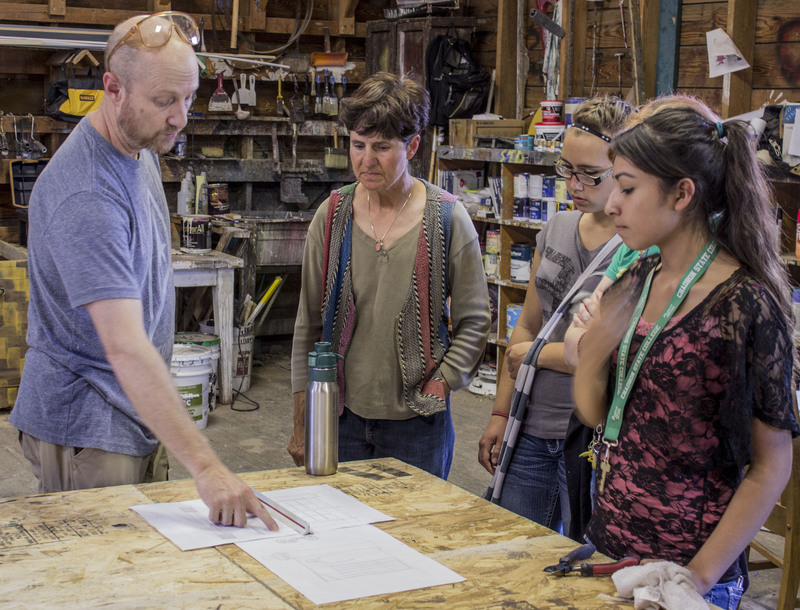 Season Scenic Designer Mark Delance, left, explains the use of math in scaling his drawings to actual construction size stage scenery to four Upward Bound students last week during a backstage tour of the Post Playhouse at Fort Robinson State Park. (Frank Bright/Chadron State College)