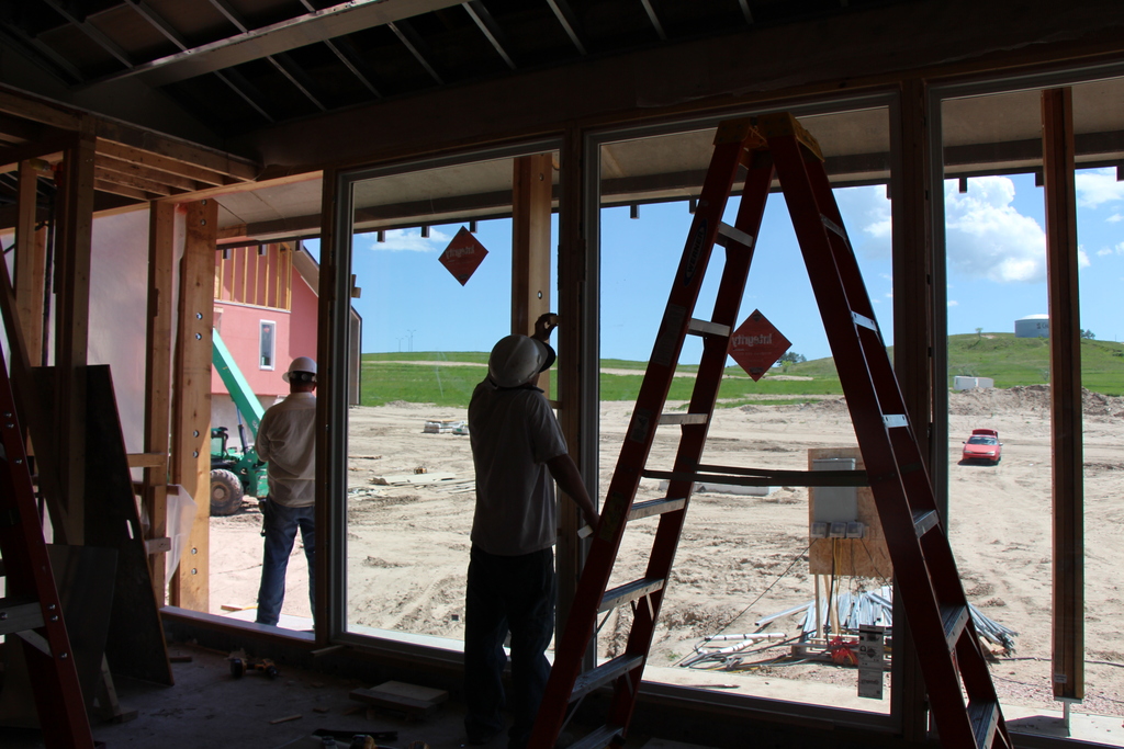 Sampson Construction and subcontractor crews install windows on the south side of the common room in the center Eagle Ridge housing unit. Fall room reservations are still being accepted for Chadron State College juniors and seniors. (Tena L. Cook/Chadron State College)