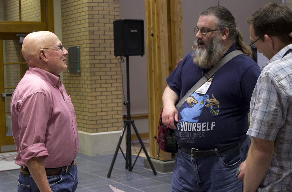 Author and keynote speaker Dan O'Brien, left, speaks with Story Catcher Writing Workshop participant John Noonan of Chadron, Tuesday evening following O'Brien's keynote speech. (Photo by Tena L. Cook)