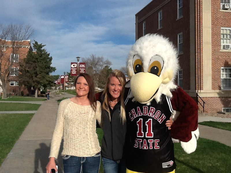 Incoming Chadron State College student Kate Basler of Akron, Colorado, and her older sister, Chris, pose with Elmo prior to the April 18 Signing Day.