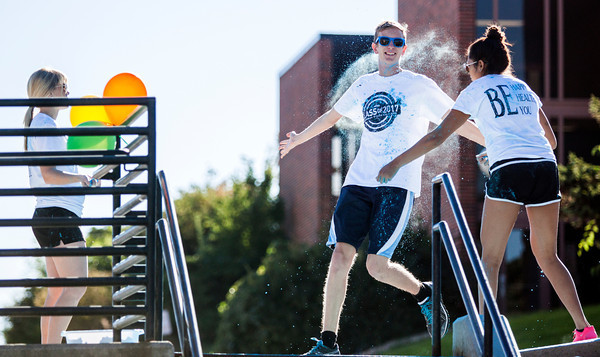 A CSC student gets a splash of color while running in the Powder to the People 5k on Saturday morning on campus during Family Day 2013.