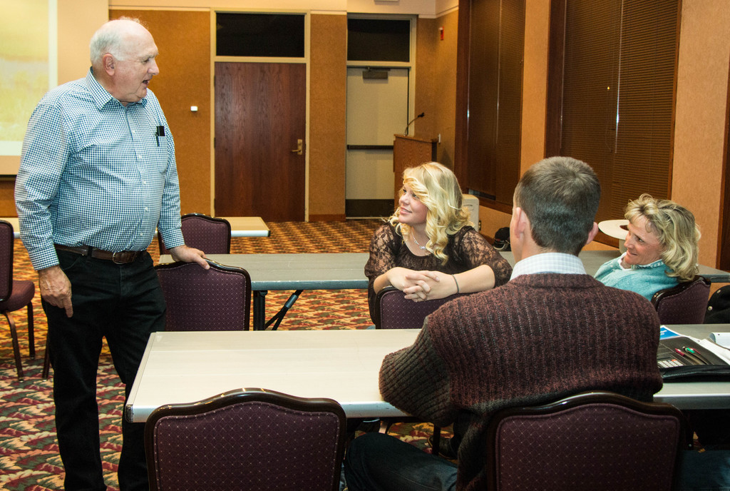 Ranching consultant Burke Teichert, left, speaks with CSC student Brandi Bailey of Lakeside, Nebraska, center, and others during a break in his presentation Friday night in the CSC Student Center. (Tena L. Cook/Chadron State College)