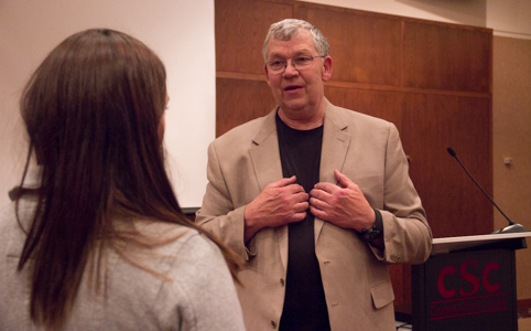 Retired FBI Special Agent and Chadron State College graduate Ron Rawalt speaks with Teri Robinson