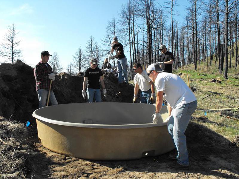 Members of the Chadron State College Rocky Mountain Elk Foundation club work on a water tank for wildlife.