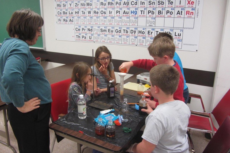 Chadron State College faculty member Dr. Ann Buchmann watches as a group of students attending the Science Saturday program.