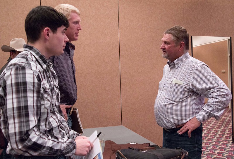 Chadron State College students Dusty Runner and Will Krause speak with Tony Malmberg.