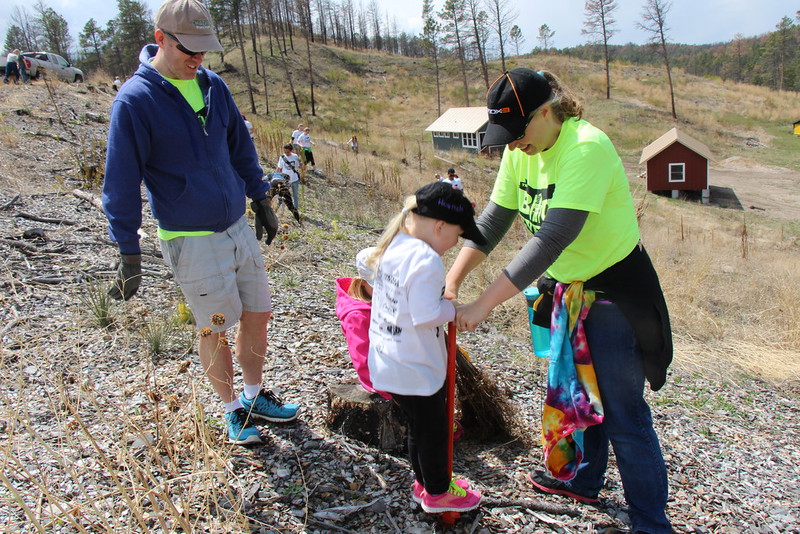 CSC faculty members and The Big Event volunteers Todd and Wendy Jamison plant trees with their daughters.