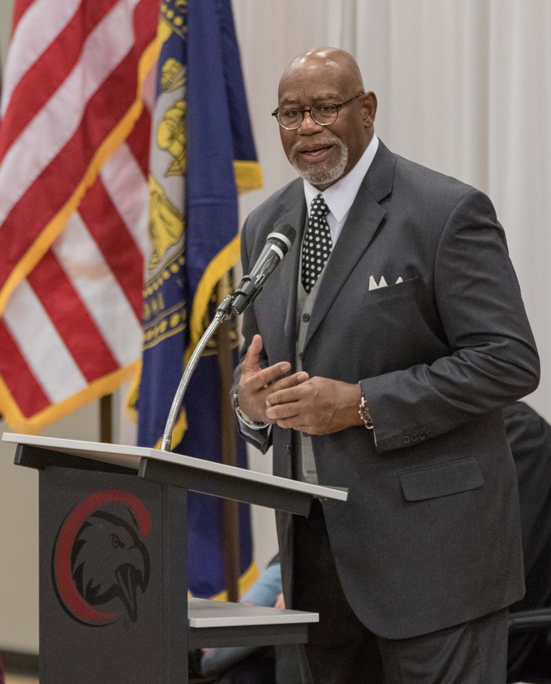 Ronn Jeffrey speaking in front of a podium.