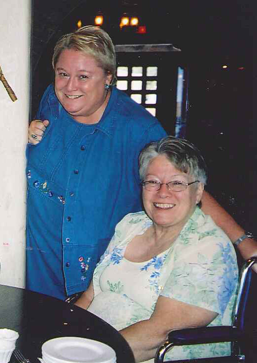 Beth Johnson, standing, with her sister, Cathy Hall, seated.