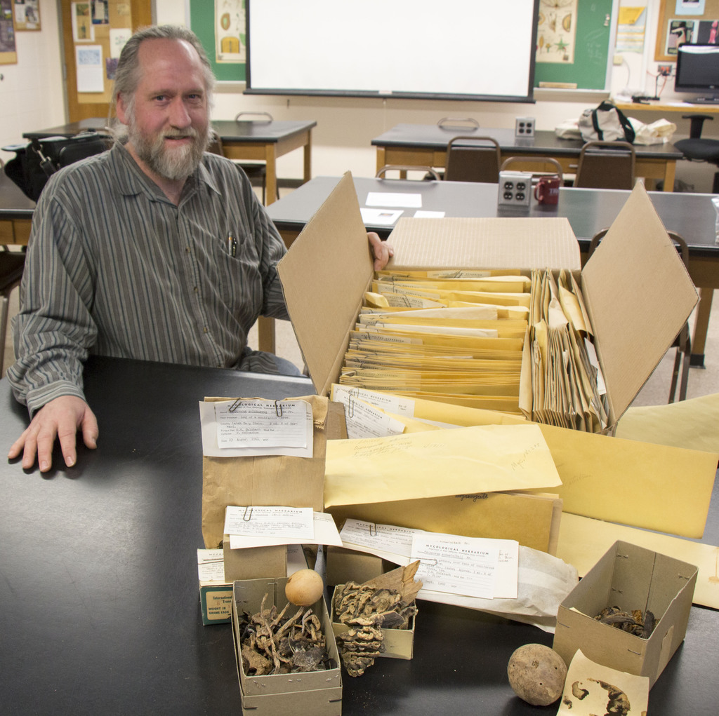 Steve Rolfsmeier, director of the High Plains Herbarium, poses with specimens..