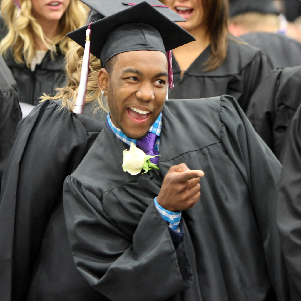 Chadron State College graduate Justyn Anderson points to friends and family