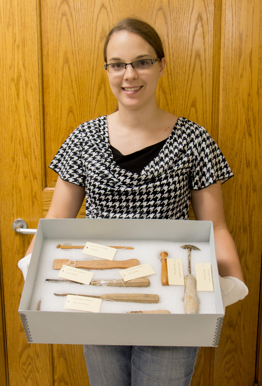 Jodi Birch poses with a set of tools once owned by William Artis.