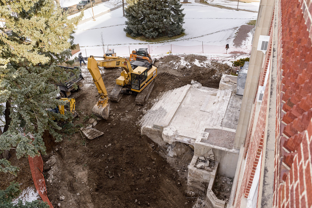 Members of Fuller Construction work on demolishing the entrance to Crites Hall.