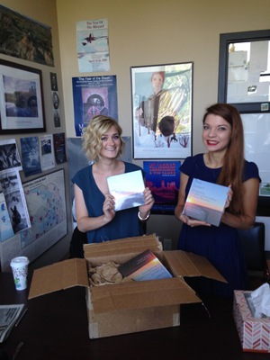 Two students display copies of the book they created