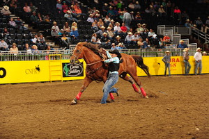 Shelby Wichell tying her first goat at the rodeo