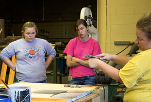 Amy Campion demonstrates set painting to students