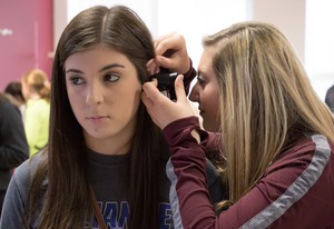 Jade Stinson looks into the ear of Kassandra Gomez