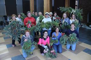 Campus Arboretum Volunteers pose with their greenery creations