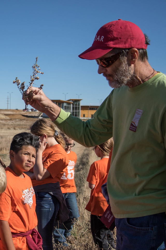 Practitioner-in-Residence Bill Whitney describes prairie plants to more than 100 Crawford school children Monday, Oct. 31, 2016