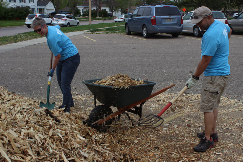 Dr. Tracy Nobiling, associate professor of justice studies, left, and Dr. Jamie Wada, associate professor and department chair of justice studies, help spread mulch at the Dawes County Courthouse during The Big Event in 2016.