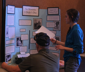 Jada Mader explains her exhibit to Randy Krueger