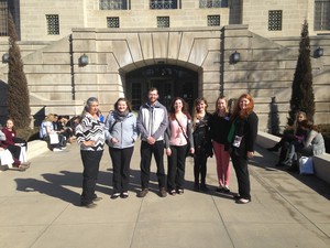 Students and faculty pose in front of the Nebraska Capitol