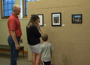 A family viewing Unity through Community exhibit