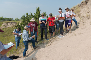 Dr. Mike Leite works with students while hiking