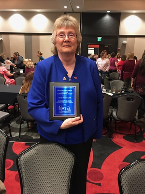 Dr. Beth Wentworth poses with award