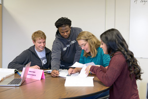 Miles Chasek works with group of students