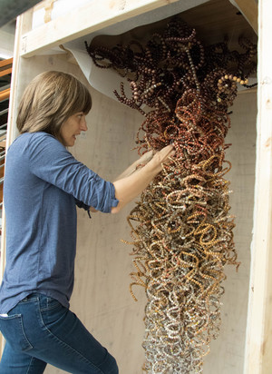 Krista Birnbaum prepares her beaded sculpture