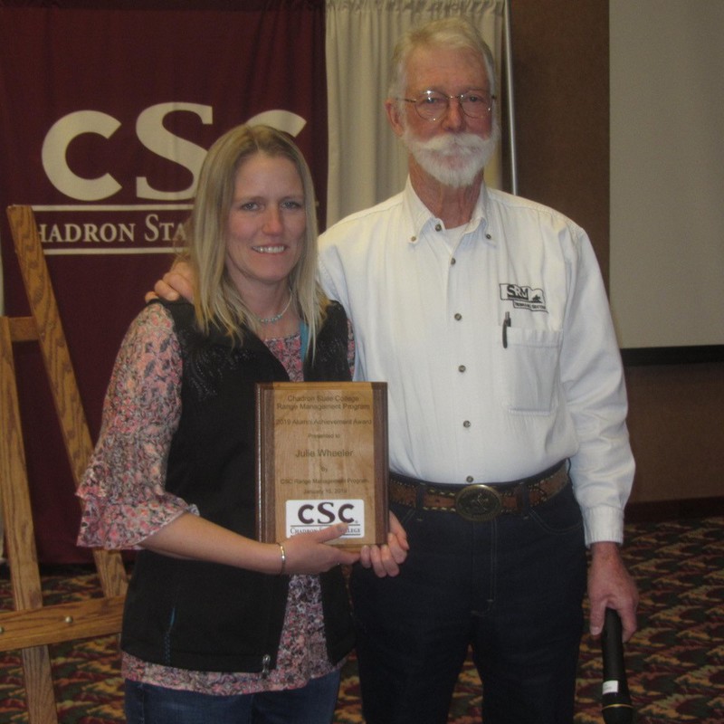 Chadron State College emeritus professor Jim O'Rourke, left, presents the 2019 Range Management Alumni Award to Julie Wheeler of Sundance, Wyo., at the Range Day program on Tuesday, Jan. 19, 2019