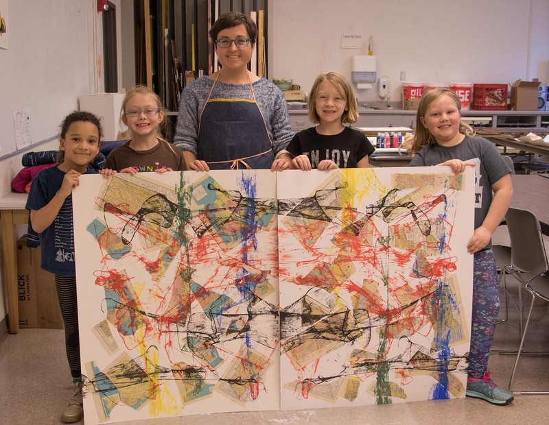 Chadron State College alumna Whitney Tewahade poses with students at the local Girl Scouts ArtVenture Sunday, Jan. 28, 2018