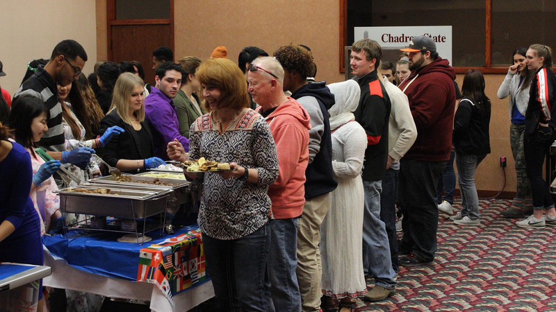 Attendees at the International Food Tasting event enjoy different homemade dishes from various cultures March 19, 2016, in the Chadron State College Student Center. (Photo by Alex Coon/Chadron State College)