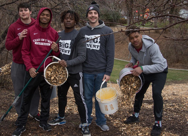 Members of the Chadron State College football team spread wood chips at Wilson Park as part of The Big Event Saturday, April 21, 2018.