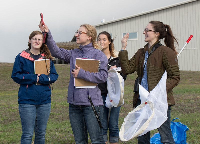 Practitioner in Residence Dr. Katherine Kral-O'Brien, right, assists Chadron State College student Josee Hotz test wind speed during a Special Topics in AGRI: Pollinator Ecology (AGRI 460) activity, Thursday, April 25, 2019